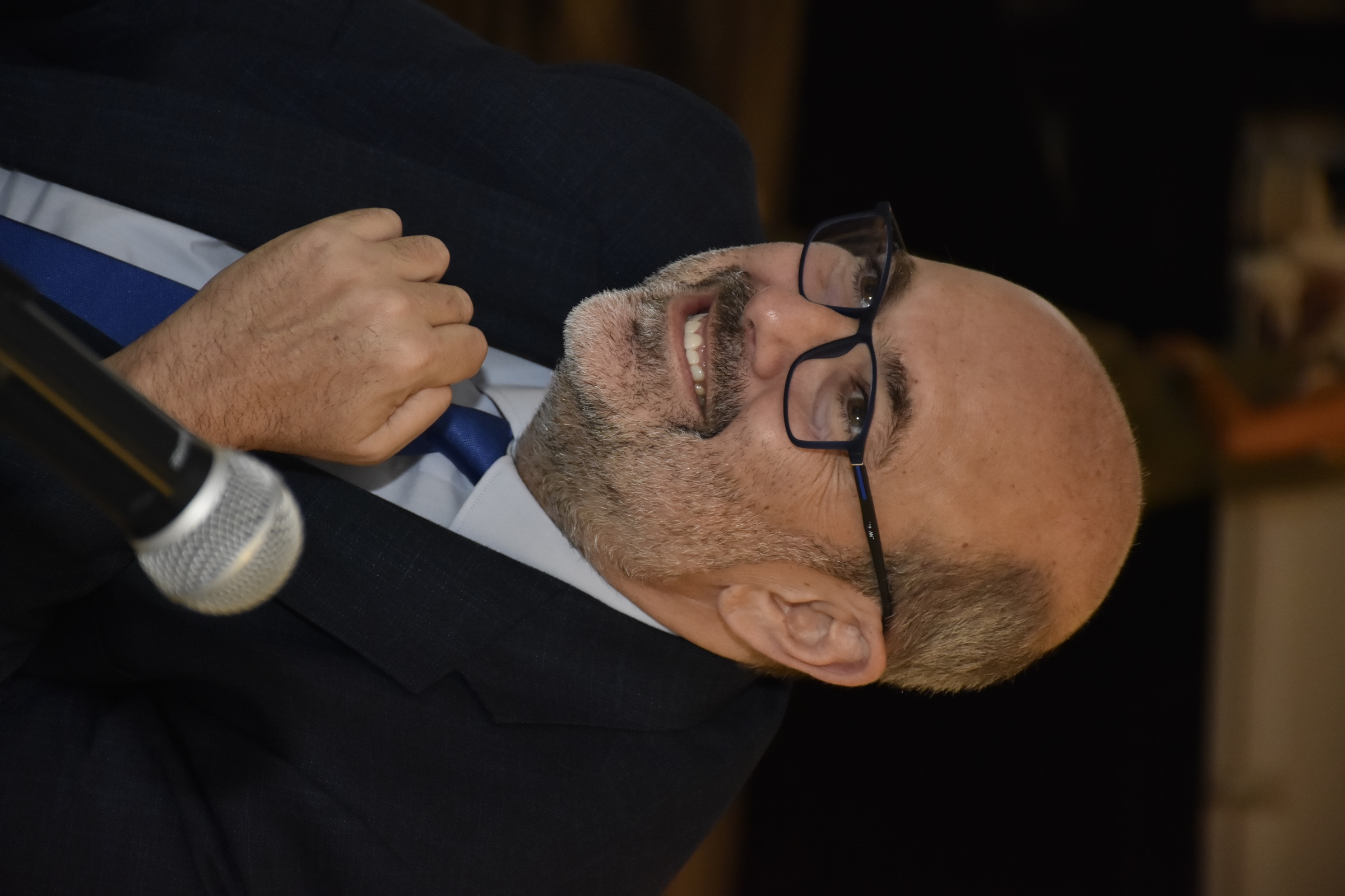 Dr. Fawaz Hamidi speaking at a professional event